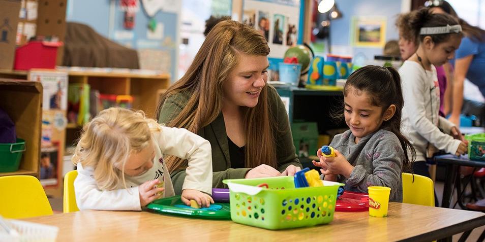 Student teacher working with children in classroom